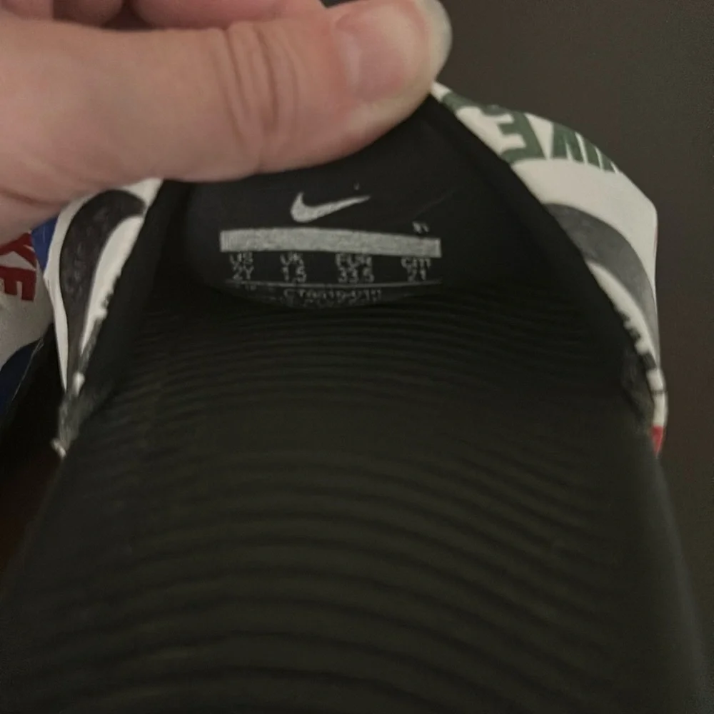 Nike black white/multiple colored slides size 2Y!